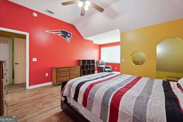 bedroom with wood-type flooring, ceiling fan, and vaulted ceiling