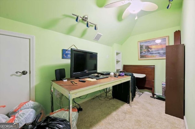 office space featuring a ceiling fan, light carpet, vaulted ceiling, and visible vents