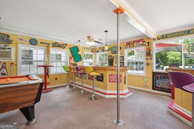 rec room featuring beam ceiling, ceiling fan, and plenty of natural light