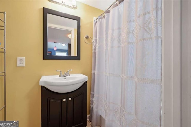 full bath with a shower with shower curtain and vanity