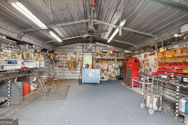 garage with a workshop area and ceiling fan