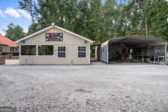 exterior space featuring gravel driveway and a carport