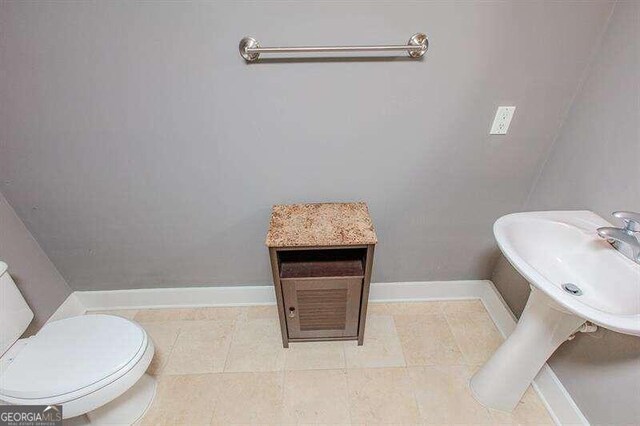 bathroom with tile patterned floors and toilet