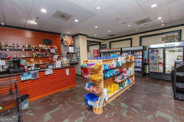 interior space with a drop ceiling and tile patterned floors