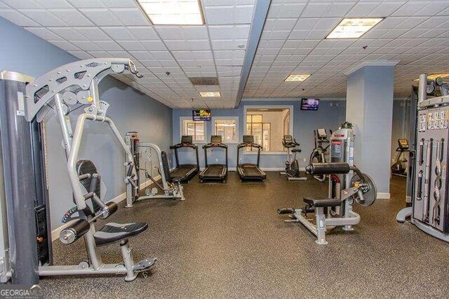 exercise room featuring a drop ceiling