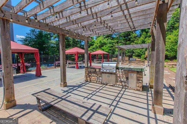 view of patio with a pergola, grilling area, and area for grilling