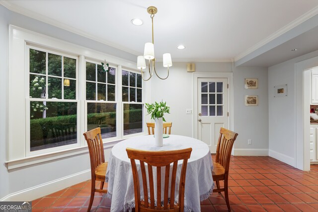 dining space featuring an inviting chandelier, tile patterned flooring, and crown molding