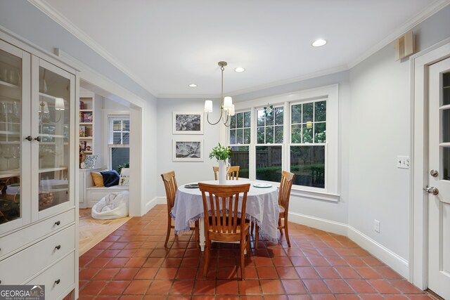 tiled dining area with ornamental molding and an inviting chandelier