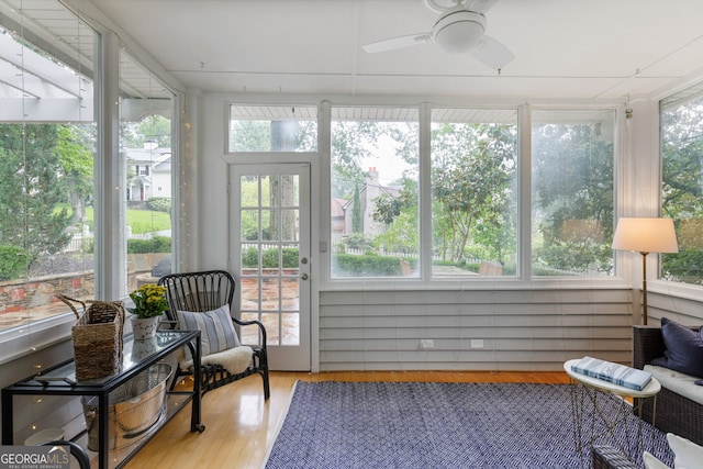 sunroom / solarium featuring ceiling fan and plenty of natural light