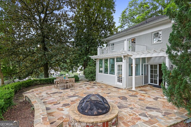 view of patio with a pergola and a fire pit