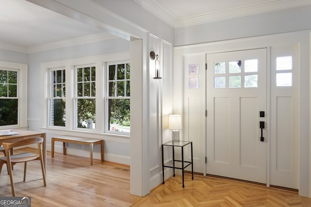 foyer featuring crown molding and plenty of natural light