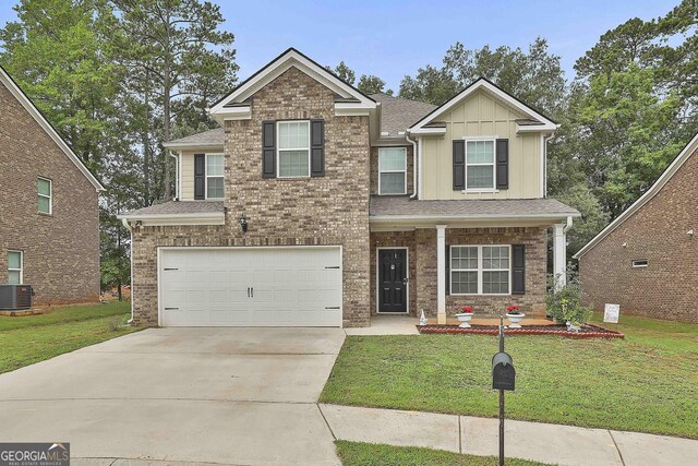 craftsman inspired home featuring central air condition unit, a garage, and a front lawn