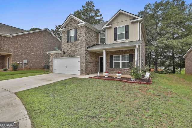 craftsman-style home featuring a garage, central air condition unit, and a front yard