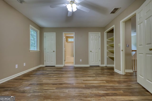 unfurnished bedroom with wood-type flooring, connected bathroom, and ceiling fan