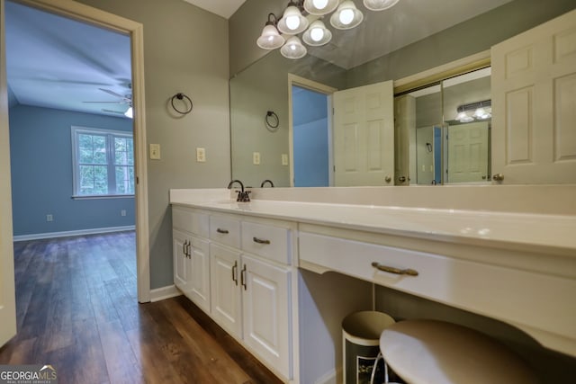 bathroom with vanity, hardwood / wood-style flooring, and ceiling fan