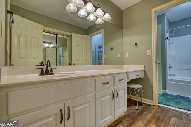 full bath with wood finished floors, vanity, baseboards, and shower / bath combo with shower curtain