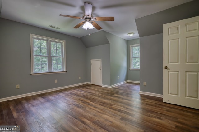 unfurnished bedroom with dark wood-type flooring, ceiling fan, and lofted ceiling