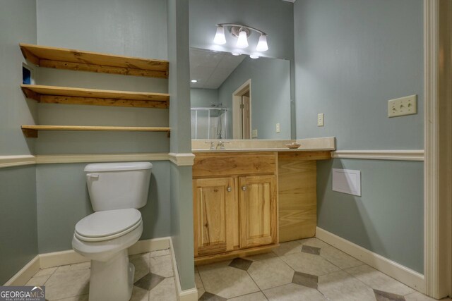 bathroom featuring tile patterned flooring, toilet, and vanity