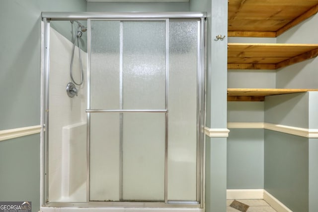 bathroom featuring tile patterned floors, walk in shower, and wood ceiling