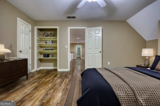 bedroom with vaulted ceiling, hardwood / wood-style floors, and ceiling fan