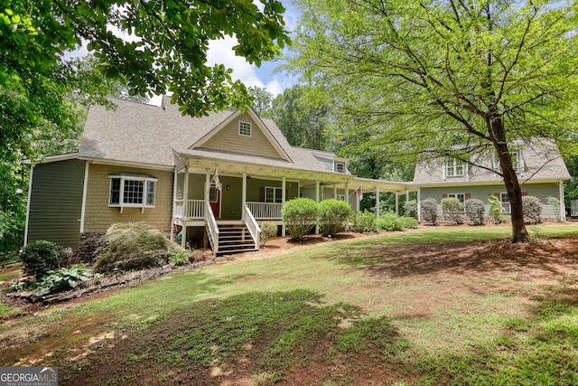 view of front of home featuring covered porch and a front yard