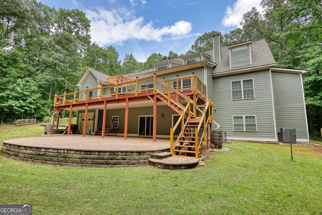 rear view of house with a lawn, a patio, a chimney, stairway, and a deck