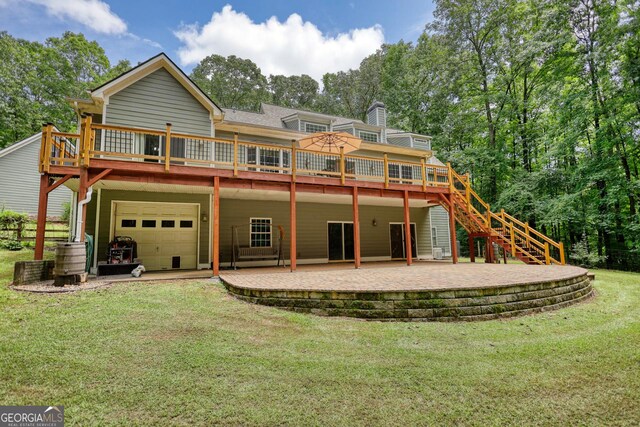 rear view of property with a deck, a patio area, and a yard