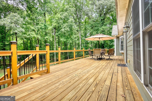 wooden terrace with outdoor dining area