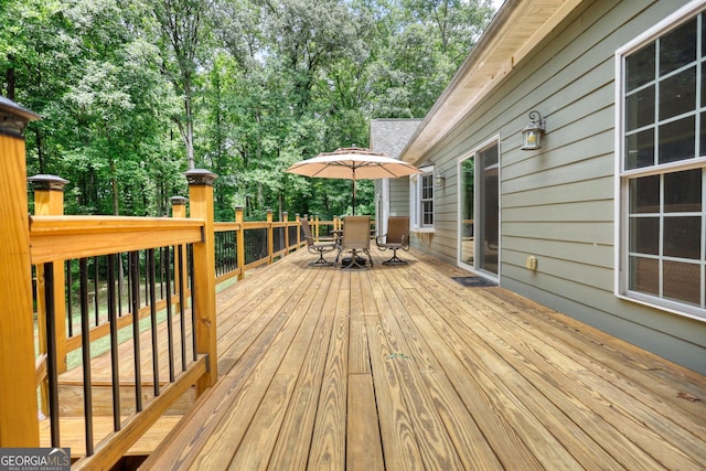 wooden terrace featuring outdoor dining space