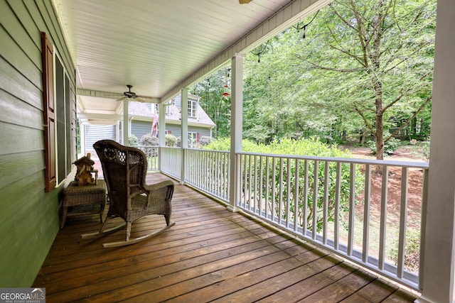 wooden deck with a ceiling fan and covered porch