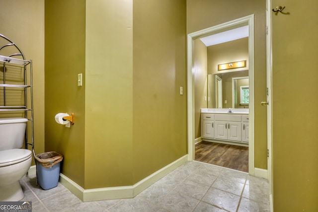 bathroom with tile patterned flooring, toilet, and vanity