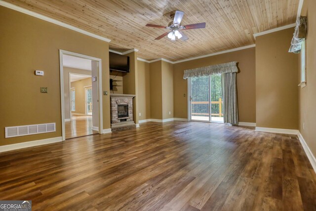 unfurnished living room with hardwood / wood-style floors, a stone fireplace, and wood ceiling