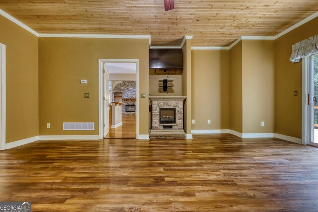 unfurnished living room featuring ornamental molding, a fireplace, wooden ceiling, and hardwood / wood-style flooring