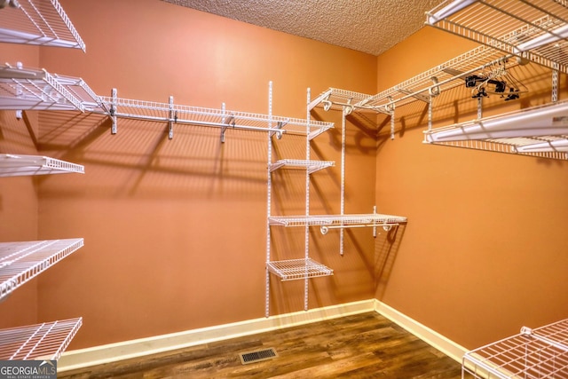 spacious closet with wood finished floors and visible vents