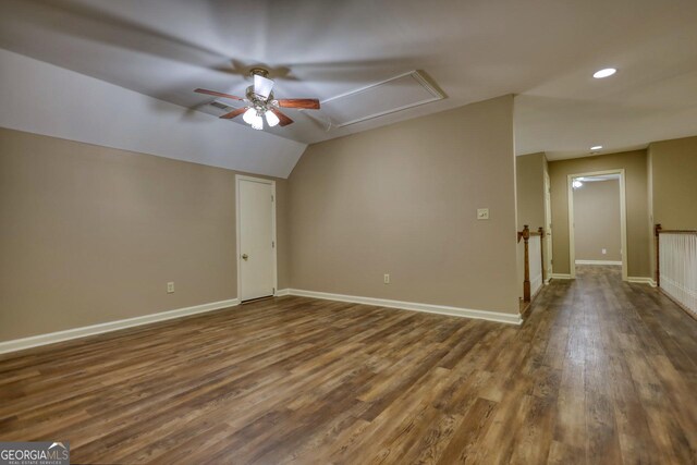 empty room with vaulted ceiling, ceiling fan, and hardwood / wood-style floors