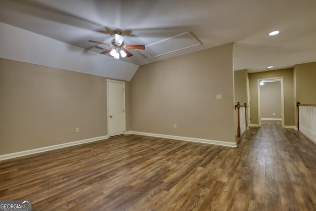 additional living space featuring dark wood-style flooring, lofted ceiling, recessed lighting, ceiling fan, and baseboards