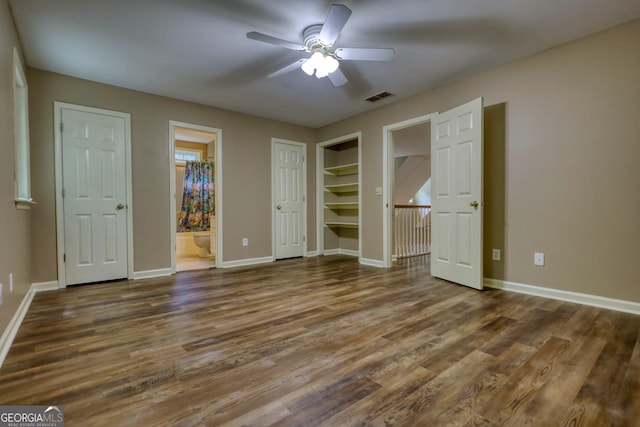 unfurnished bedroom featuring ensuite bath, ceiling fan, and hardwood / wood-style flooring