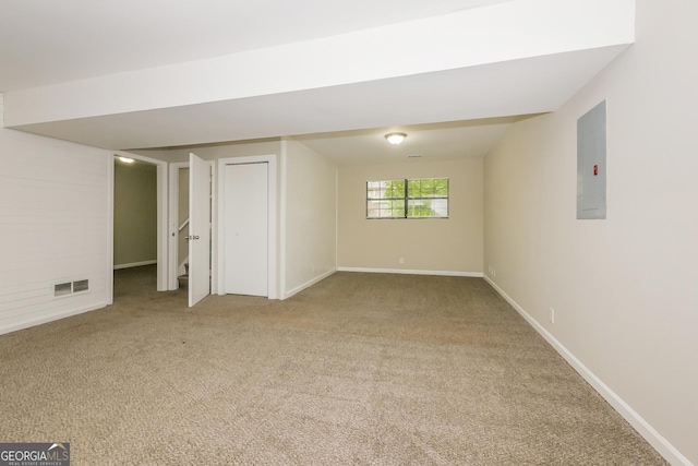 basement featuring electric panel and carpet