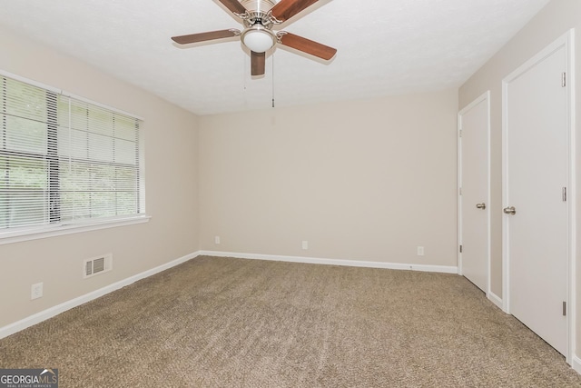 unfurnished room with ceiling fan and carpet flooring