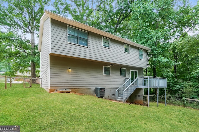 back of house with cooling unit, a wooden deck, and a yard