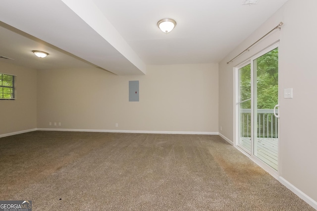 carpeted spare room featuring electric panel