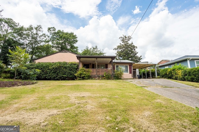 single story home with driveway, a carport, and a front yard