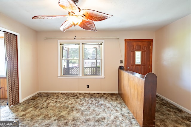 carpeted entrance foyer featuring ceiling fan