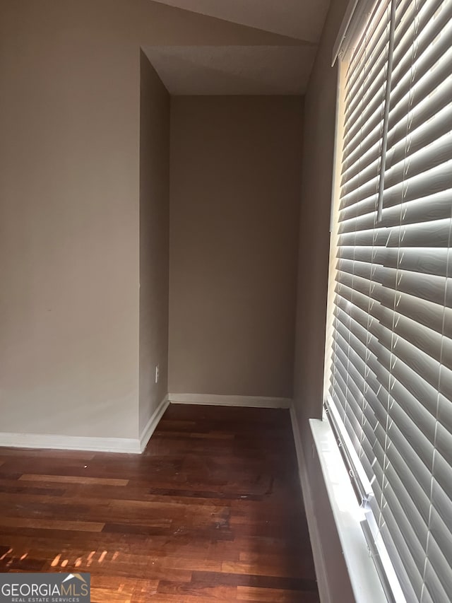 unfurnished room with wood-type flooring