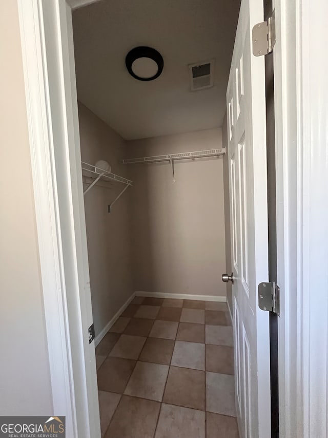 spacious closet featuring light tile patterned floors