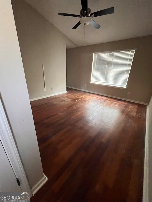 empty room featuring ceiling fan, wood-type flooring, and vaulted ceiling