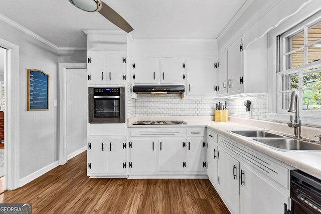 kitchen featuring stainless steel appliances, tasteful backsplash, sink, and white cabinets