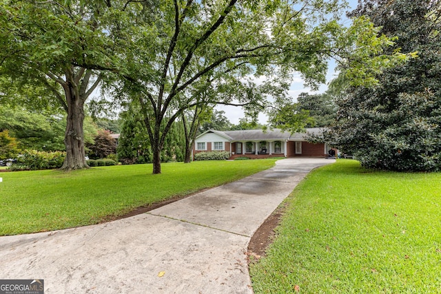 ranch-style home featuring a front yard