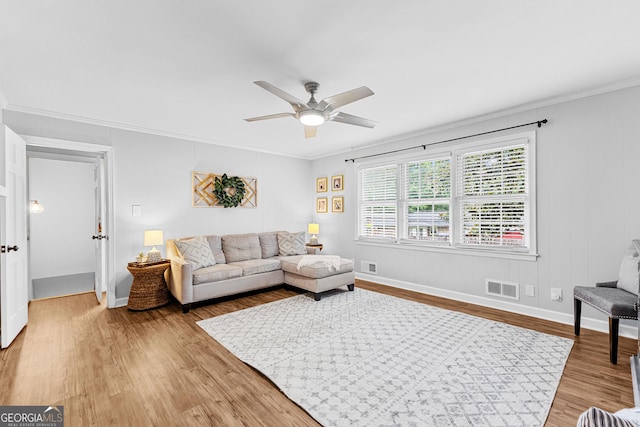 living room featuring crown molding, ceiling fan, and hardwood / wood-style floors