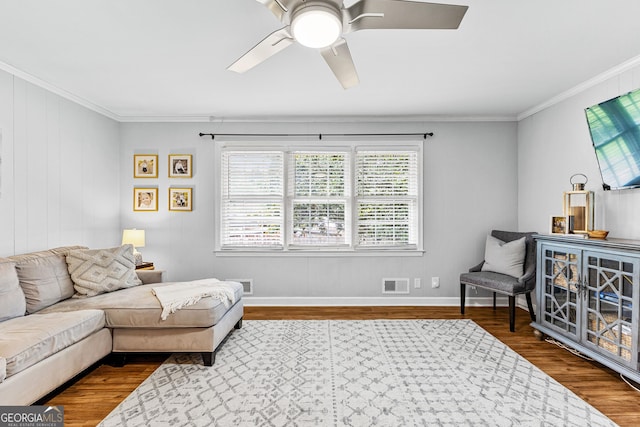 living room featuring crown molding, ceiling fan, and hardwood / wood-style flooring